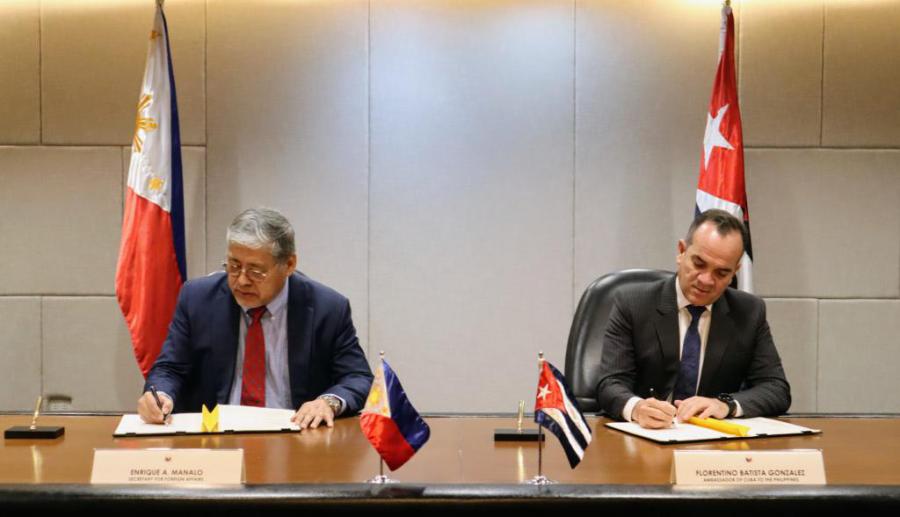 (Left) Secretary for Foreign Affairs Enrique A. Manalo and (right) Non-Resident Ambassador of Cuba to the Philippines Florentino Batista González sign the Memorandum of Understanding on Political Consultations between the Philippines and Cuba.