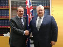 Minister Brownlee (r) greets the Cuban Ambassador (l)